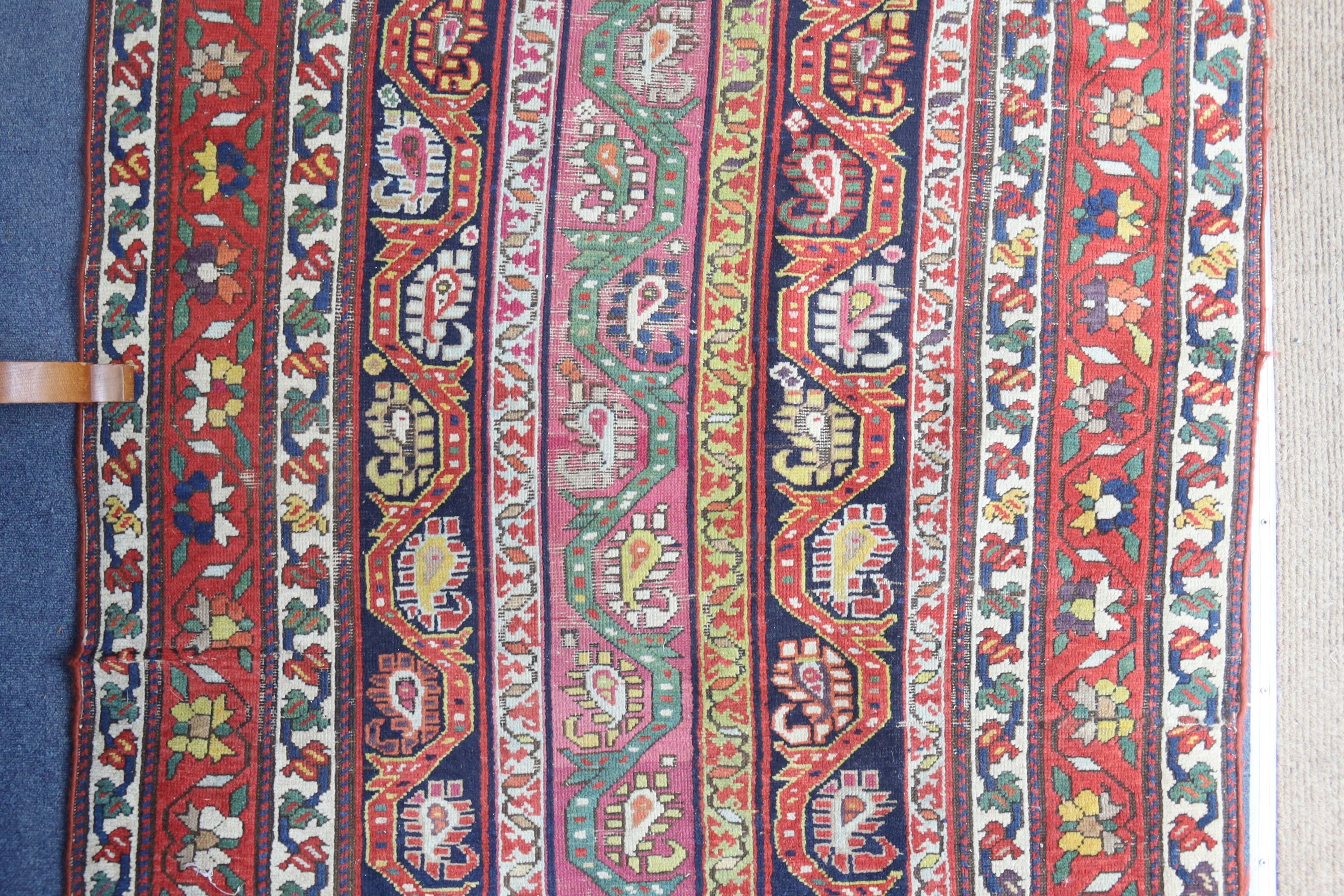 A Caucasian design Boteh red ground rug, 236 x 116cm